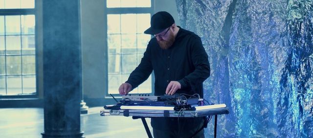 Man playing electronic music instruments