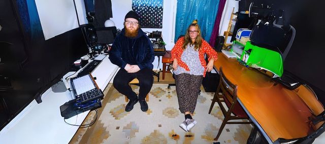 Man and woman sitting in music studio